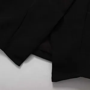 Macro view showing the fine fabric and slit hem detail of this elegant black pencil skirt