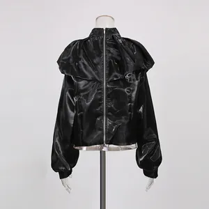 Detailed back view of a shiny black long-sleeve crop top featuring a full-length zipper