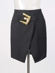 Elegant black high-waisted bodycon slit skirt with decorative large gold metal buckle