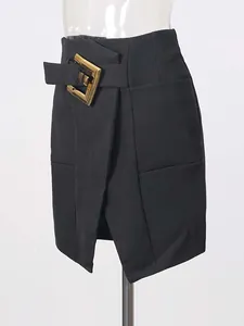 Elegant black bodycon mini skirt featuring a vintage gold buckle belt and front slit design