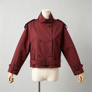 Front view detail of a short burgundy women trench jacket with high collar and belt detail