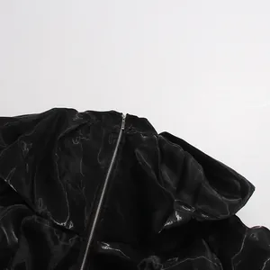 Close-up showing the refined metal zipper and textured fabric of this black elegant blouse.