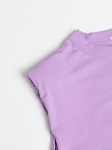 Detail of purple round-neck dress showing high-quality fabric and shoulder padding.