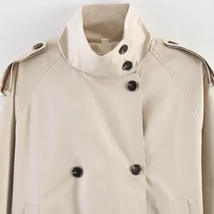 Close-up of British style beige trench coat featuring stand collar and epaulettes