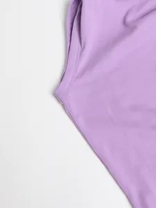 Close-up detail of lavender purple fabric and shoulder seam on a solid color dress