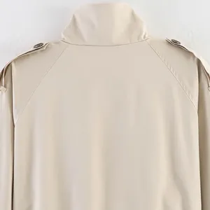 Close-up detail of the collar and epaulets on a beige vintage English trench coat