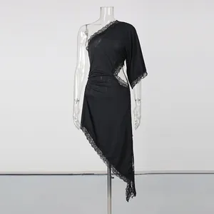 Detailed view of black one-shoulder asymmetrical dress with lace trim and cut-out