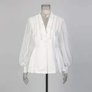 Front view of elegant white V-neck blouse with pearl shoulder embroidery details