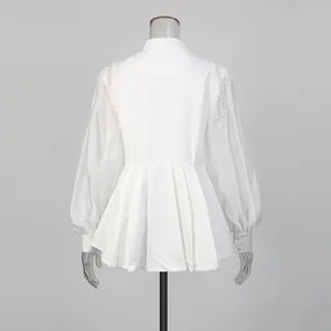 Back view of elegant white lantern sleeve blouse with pearl shoulder details.