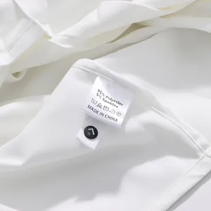 Detail of white shirt care label showing polyester and spandex material mix