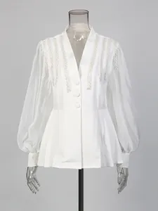 Elegant white V-neck lantern sleeve shirt featuring intricate beaded shoulder details