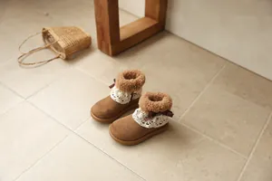 Detailed view of brown girls' winter boots featuring elegant lace trim and cozy fleece lining.