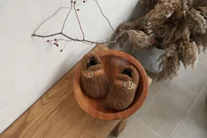 Cozy brown fleece-lined children's plush shoes with leather buckle strap detail