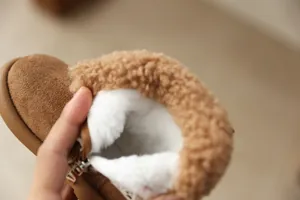 Close-up detail of warm white plush lining and brown teddy fur collar on girls' winter boots