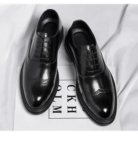 Detailed view of elegant black leather Brogue dress shoes with wingtip perforations