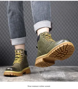 Detailed view of the wear-resistant rubber outsole on green leather work boots.