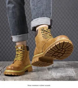 Close-up view of men's leather work boots featuring a wear-resistant rubber outsole.