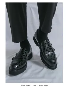 Vue détaillée des chaussures de ville noires en cuir verni à pois pour hommes élégants.