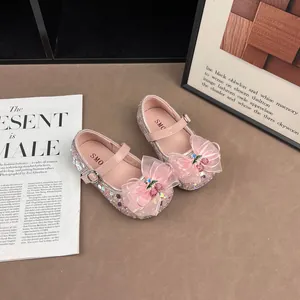 Close-up of pink sequined girls princess shoes with bow and cherry decorations