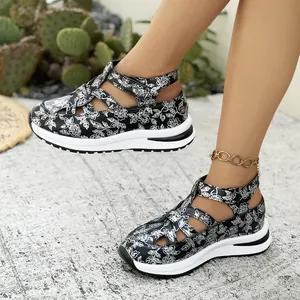 Detailed shot of women's black and white floral print platform sandals with Velcro
