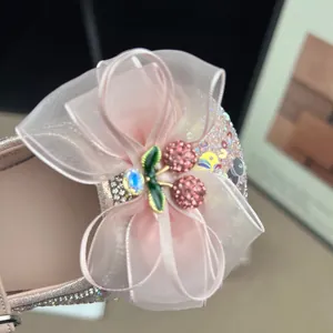 Close-up of pink girls' princess shoe featuring mesh bow and cherry charm detail