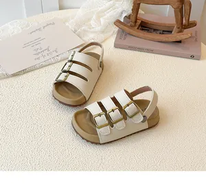 Cream children's sandals with three adjustable buckles displayed on an aesthetic background