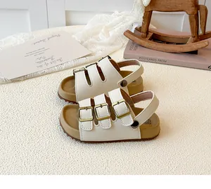 Elegant children's white cork sole sandals featuring three adjustable gold buckles detail