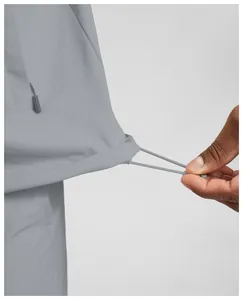 Close-up detail of adjustable drawstring hem on men's grey water-repellent jacket