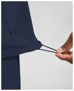 Detailed view of the adjustable elastic drawstring hem on a navy blue men's sports jacket