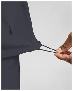 Close-up of men's quick-dry athletic jacket featuring an adjustable drawstring hem