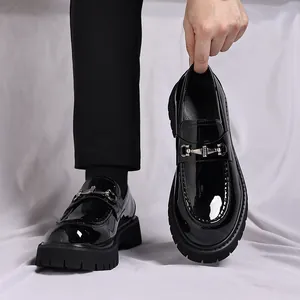 Detaillierte Nahaufnahme schwarzer Herren-Plateau-Loafer aus Lackleder mit Silberschnalle