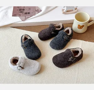 Close-up of children's warm fur-lined Birkenstock-style clogs in various autumn colors.