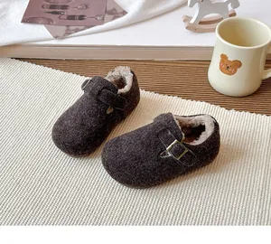 Close-up of brown vintage children's winter shoes with warm fleece lining and buckle strap