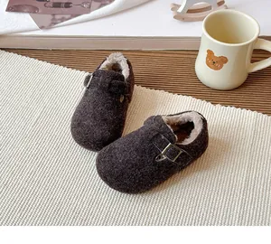 Detailed view of brown retro kids clogs with warm plush lining and buckle strap