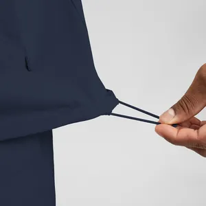 Close-up of adjustable hem drawstring on eco-friendly navy men's athletic jacket