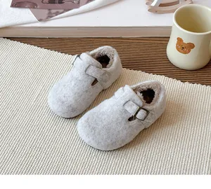 Detail of children's winter clogs with warm plush lining and adjustable buckle strap
