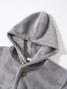 Macro view of men's gray coral fleece hoodie showing texture and internal size label