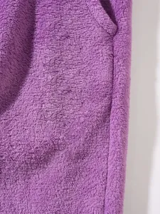 Macro detail shot of purple thick fleece material showing soft and warm fabric texture