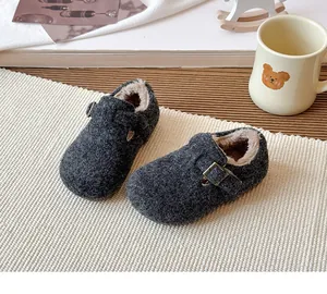 Close-up of cozy grey children's winter shoes with warm faux fur lining and buckle