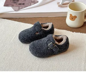 Close-up of children's charcoal grey felt Birkenstock shoes featuring warm plush fur lining.
