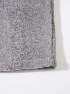 Close-up of soft grey coral fleece fabric and hem stitching on a men's winter jacket