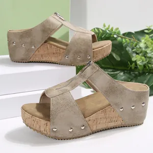 Taupe wedge sandals for women with metallic faux suede upper, front zipper, and cork sole.