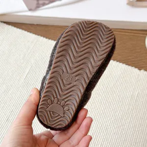 Close-up of anti-slip rubber sole with size 23 on children's warm plush winter slippers