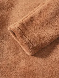 Detailed macro shot showcasing the soft texture of the brown coral fleece sleeve cuff