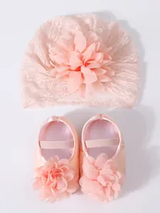 Set of pink baby lace turban hat with flower and matching soft princess shoes.