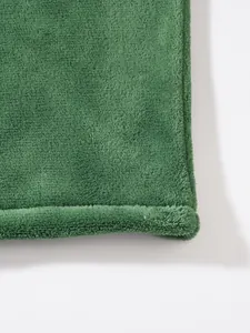 Detail view of the soft green coral fleece texture on a warm men's winter hoodie
