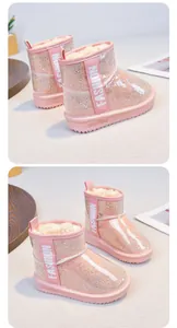 Detail view of pink rhinestone snow boots with waterproof layer and warm lining.