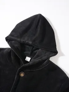 Close-up of soft black coral fleece hooded jacket showing texture and button detail