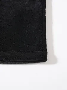 Detailed macro shot of black coral fleece fabric texture on a men's winter jacket