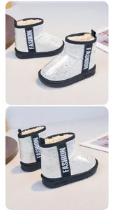 Detail view of white glitter children's snow boots with warm faux fur lining and sequins.
